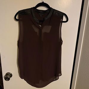 This light airy top has fake suede decor with a really cute cut out open back.